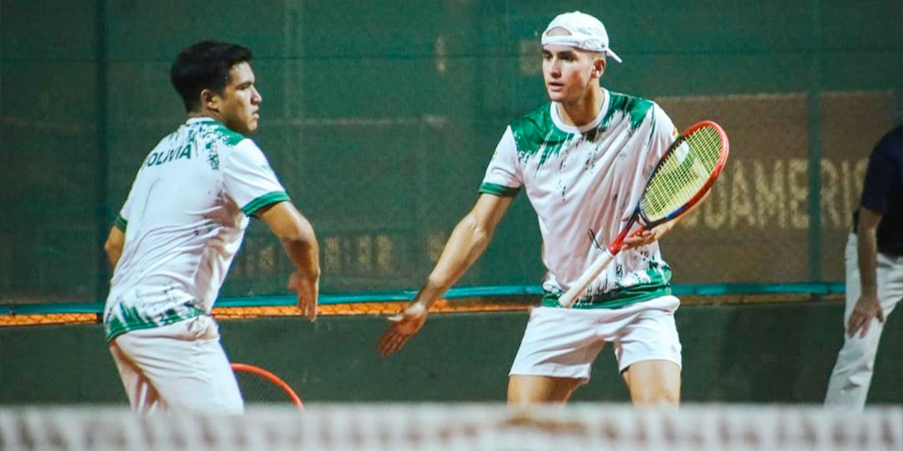 Los tenistas bolivianos Agustín Cuéllar y Ernesto Requena festejan la victoria en dobles, que confirmó el ascenso en la Copa Davis. Foto: Asociación paraguaya de Tenis