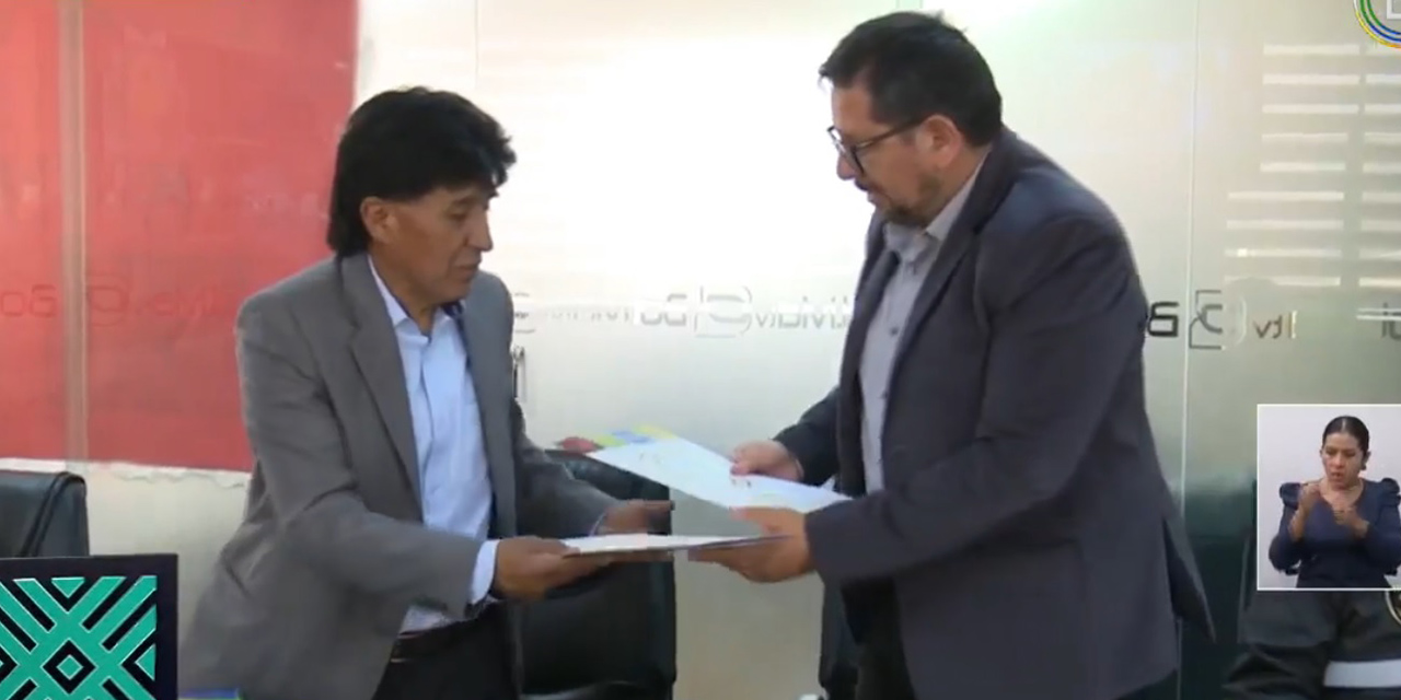 El gerente de Bolivia TV, Julio Valdivia, y el presidente de la ACFGP, Gregorio Carrillo, durante la firma. 