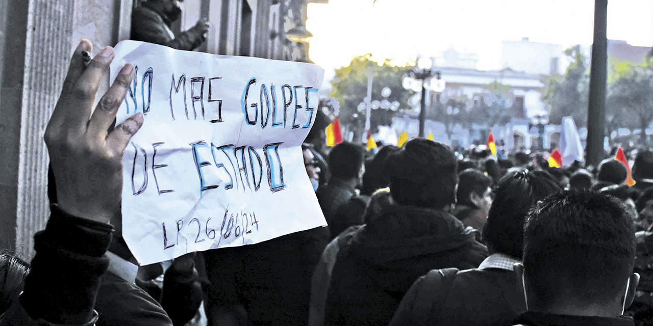 Una persona con un cartel en el que pide “No más golpes de Estado”.  | Foto: Gustavo Ticona