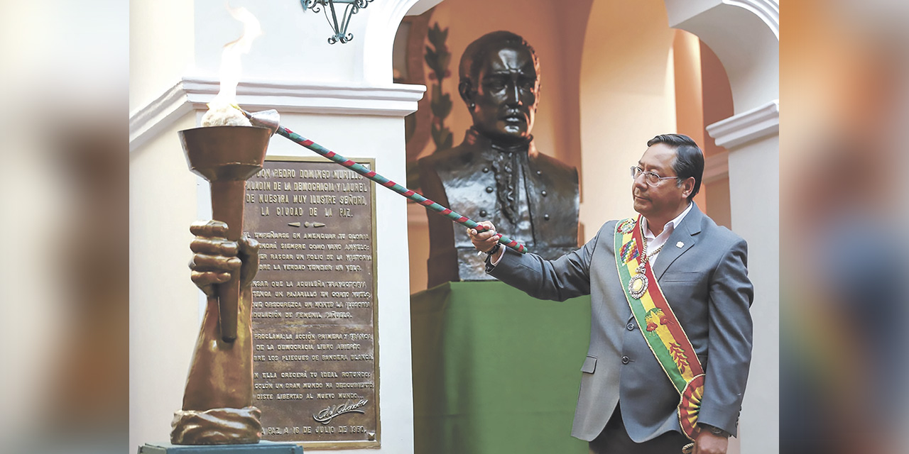 El presidente Luis Arce enciende la tea de Murillo, en la casa del protomártir, ubicada en la calle Jaén. | Foto: Presidencia